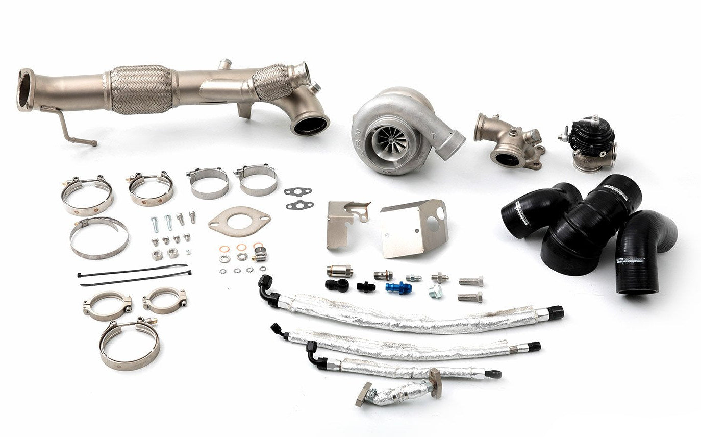 CPE parts laid out on a white background, including various metal components likely made of stainless steel or aluminium, typically used for vehicle turbocharging.